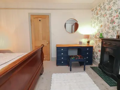 a bedroom with a bed and a dresser and a mirror at Levenside in Preston