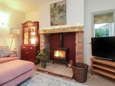 a living room with a fireplace and a tv at Levenside in Preston