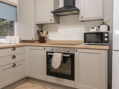 a kitchen with a stove and a microwave at Levenside in Preston