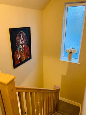 a painting of a woman on a wall next to a staircase at Newly renovated countryside retreat in Scorton in Scorton