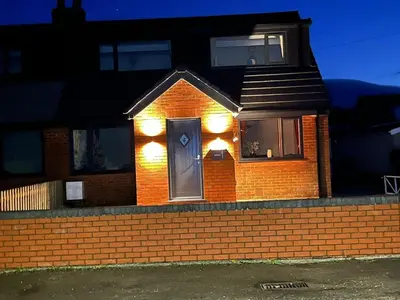 a brick house with a door with lights on it at Newly renovated countryside retreat in Scorton in Scorton