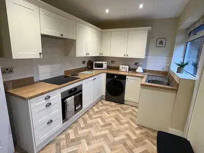 a kitchen with white cabinets and a dishwasher at Newly renovated countryside retreat in Scorton in Scorton