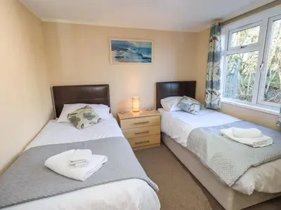 two twin beds in a room with a window at Kingfisher Lodge - Arnside 14 in Carnforth