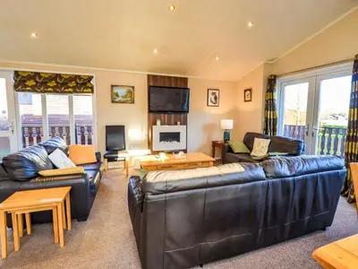 a living room with two couches and a television at Kingfisher Lodge - Arnside 14 in Carnforth
