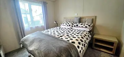 a bedroom with a bed with black and white pillows at Happy Go Lucky Lodge in Middleton