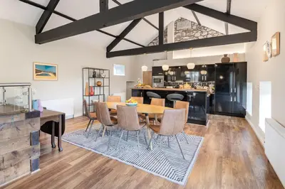 a kitchen and dining room with a table and chairs at Royal Oak Barn - Cartmel, Sleeps 8 NEW in Cartmel