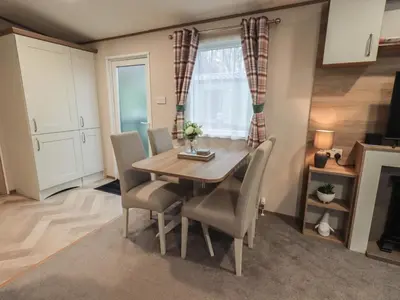 a dining room with a table and chairs at Foxwood Hideaway in Carnforth