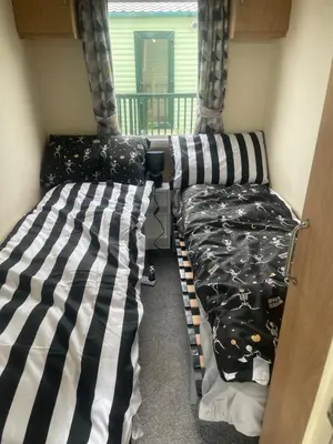 two bunk beds in a room with a balcony at Gemini in Heysham