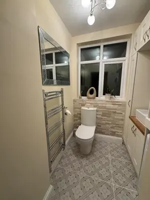 a bathroom with a toilet and a window at Entire House, Parking, Facilities, sleeps up to 6, suitable for contractors, families or NHS in Liverpool