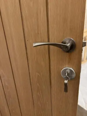 a wooden door with a metal door knob at Entire House, Parking, Facilities, sleeps up to 6, suitable for contractors, families or NHS in Liverpool