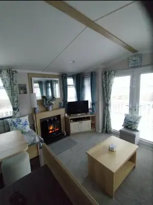 a living room with a couch and a table at The Bluebell in Haverigg