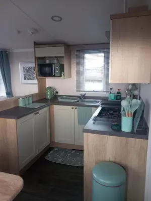 a small kitchen with a stove and a sink at The Bluebell in Haverigg