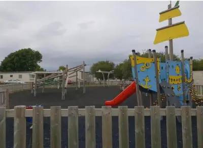 a park with a playground with a slide and a slideintend at The Bluebell in Haverigg