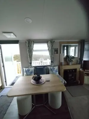 a living room with a table and a couch at The Bluebell in Haverigg