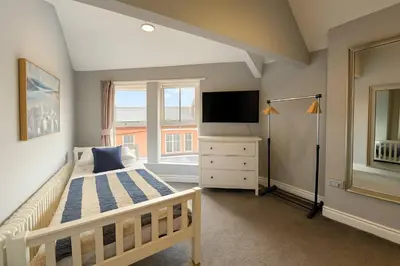 a bedroom with a bed and a television in it at Large 6 Bed Southport Coastal Retreat with Sauna in Southport