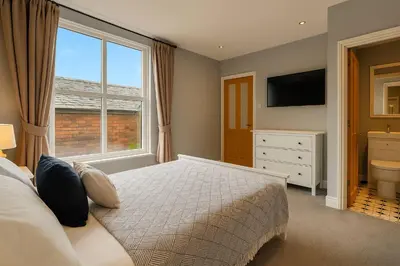 a bedroom with a bed and a large window at Large 6 Bed Southport Coastal Retreat with Sauna in Southport