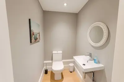 a bathroom with a white toilet and a sink at Large 6 Bed Southport Coastal Retreat with Sauna in Southport
