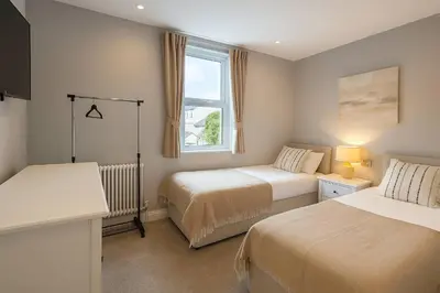 a bedroom with two beds and a window at Large 6 Bed Southport Coastal Retreat with Sauna in Southport