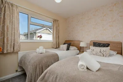 a bedroom with two beds and a window at Moorland Bungalow Central Clitheroe in Clitheroe