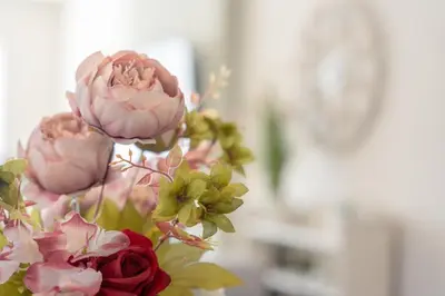 a vase filled with pink roses and other flowers at Moorland Bungalow Central Clitheroe in Clitheroe