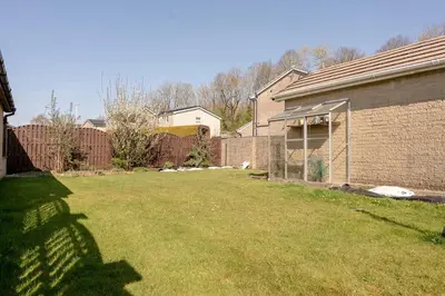 a yard with a fence and a house at Moorland Bungalow Central Clitheroe in Clitheroe