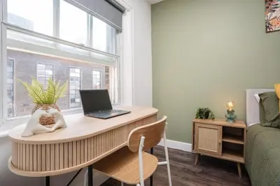 a desk with a laptop on it in a room with a window at L1 City Centre Stay! Nightlife, Close to everything! Carpark on street! in Liverpool
