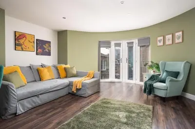 a living room with a gray couch and two blue chairs at L1 City Centre Stay! Nightlife, Close to everything! Carpark on street! in Liverpool