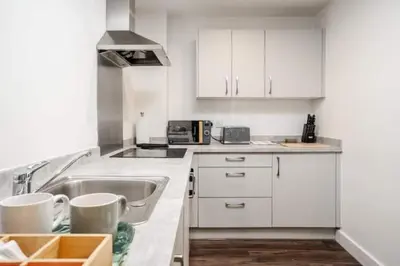 a kitchen with white cabinets and a sink at L1 City Centre Stay! Nightlife, Close to everything! Carpark on street! in Liverpool