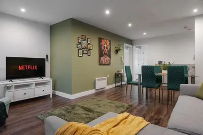 a living room with a couch and a tv and a table at L1 City Centre Stay! Nightlife, Close to everything! Carpark on street! in Liverpool