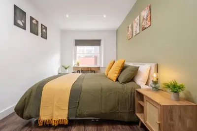 a bedroom with a large bed and a table at L1 City Centre Stay! Nightlife, Close to everything! Carpark on street! in Liverpool