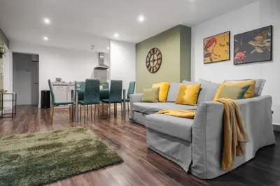 a living room with a couch and a table with chairs at L1 City Centre Stay! Nightlife, Close to everything! Carpark on street! in Liverpool