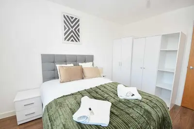 a bedroom with a bed with two towels on it at Modern 1BED Flat in Central Liverpool - City Views in Liverpool