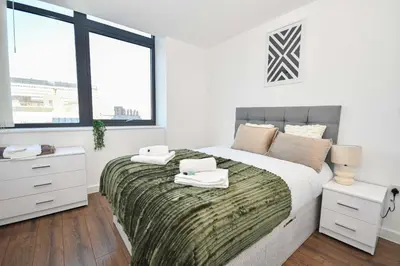 a bedroom with a bed with two towels on it at Modern 1BED Flat in Central Liverpool - City Views in Liverpool