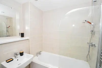 a bathroom with a shower and a tub and a sink at Modern 1BED Flat in Central Liverpool - City Views in Liverpool