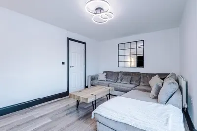 a living room with a couch and a table at Driveway Stunning 3Bedroom Home in Preston in Broughton