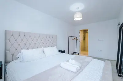 a bedroom with a white bed with two towels on it at Driveway Stunning 3Bedroom Home in Preston in Broughton