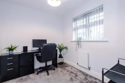 an office with a desk with a computer and a chair at Driveway Stunning 3Bedroom Home in Preston in Broughton