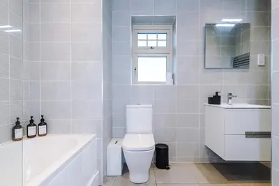 a bathroom with a toilet and a tub and a sink at Driveway Stunning 3Bedroom Home in Preston in Broughton