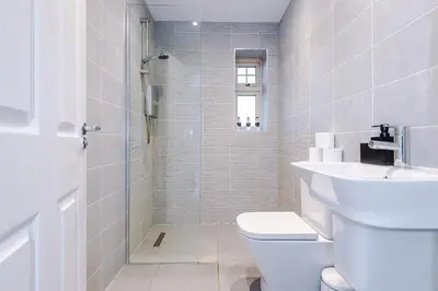 a bathroom with a shower and a toilet and a sink at Driveway Stunning 3Bedroom Home in Preston in Broughton