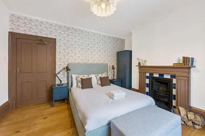 a bedroom with a bed and a fireplace at Liverpool Georgian Townhouse for Family & Groups in Liverpool