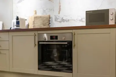 a microwave sitting on top of a counter in a kitchen at Liverpool Georgian Townhouse for Family & Groups in Liverpool