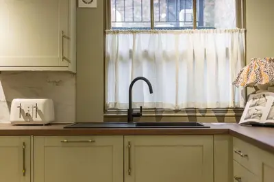 a kitchen with a sink and a window at Liverpool Georgian Townhouse for Family & Groups in Liverpool