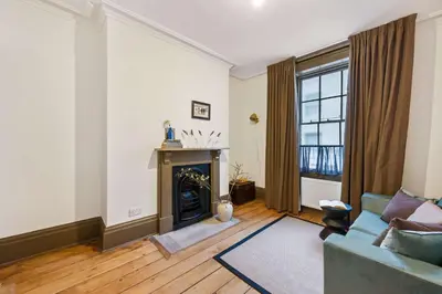 a living room with a couch and a fireplace at Liverpool Georgian Townhouse for Family & Groups in Liverpool