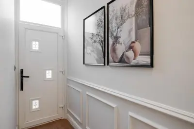 a hallway with three framed pictures on the wall at Premium 4bedroom City Home Close to LFC in Liverpool