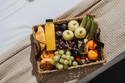 a basket filled with fruit and a bottle of juice at Premium 4bedroom City Home Close to LFC in Liverpool