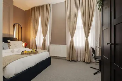 a hotel room with a bed and a window at Premium 4bedroom City Home Close to LFC in Liverpool