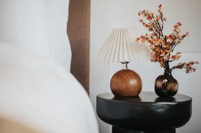 a table with a lamp and two vases with flowers at Premium 4bedroom City Home Close to LFC in Liverpool