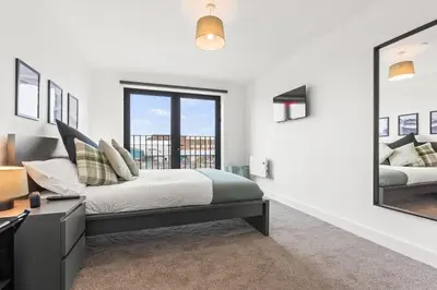 a bedroom with a bed and a large mirror at Ideal for Getaways Liverpool Flat, sleeps 4 in Liverpool