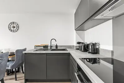 a kitchen with a sink and a stove at Ideal for Getaways Liverpool Flat, sleeps 4 in Liverpool