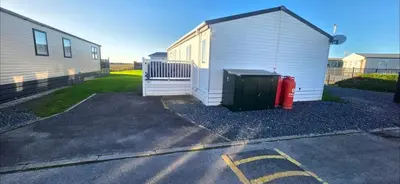 a garage with a fire hydrant next to a building at Bay View Lodge in Heysham
